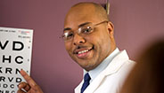 Doctor giving eye exam Doctor giving eye exam
