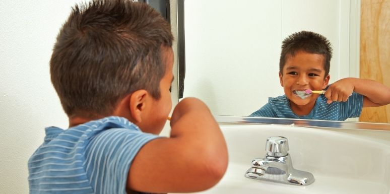 Kid brushing his teeth