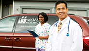 Doctor and Nurse in front of Molina Van Doctor and Nurse in front of Molina Van